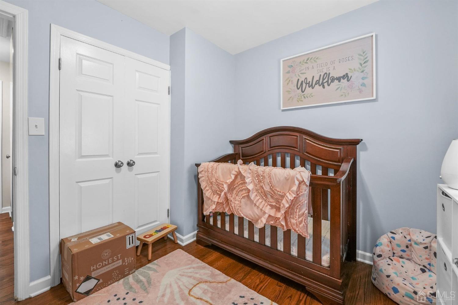 1067 Riverton Street North Brunswick, NJ 08902 - Photo 13 of 45 a bedroom with a bed and wooden floor