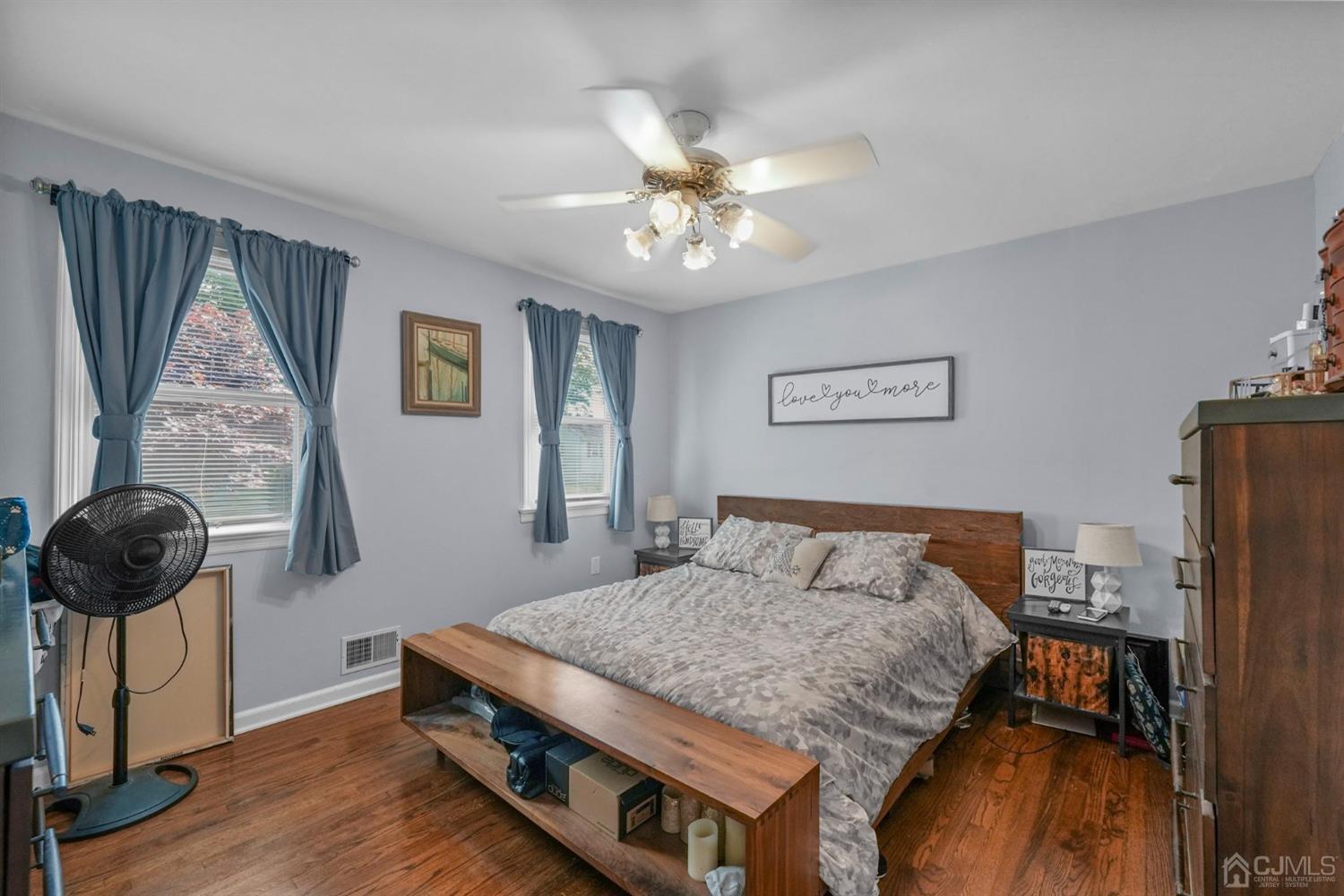 1067 Riverton Street North Brunswick, NJ 08902 - Photo 17 of 45 a bedroom with a bed and a chandelier