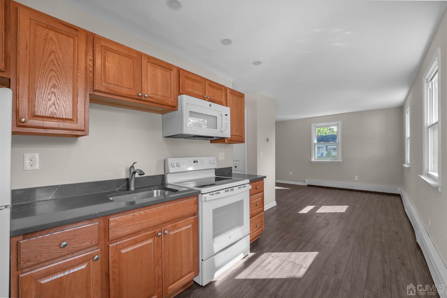 1067 Riverton Street North Brunswick, NJ 08902 - Photo 25 of 45 a kitchen with stainless steel appliances granite countertop a sink stove and cabinets