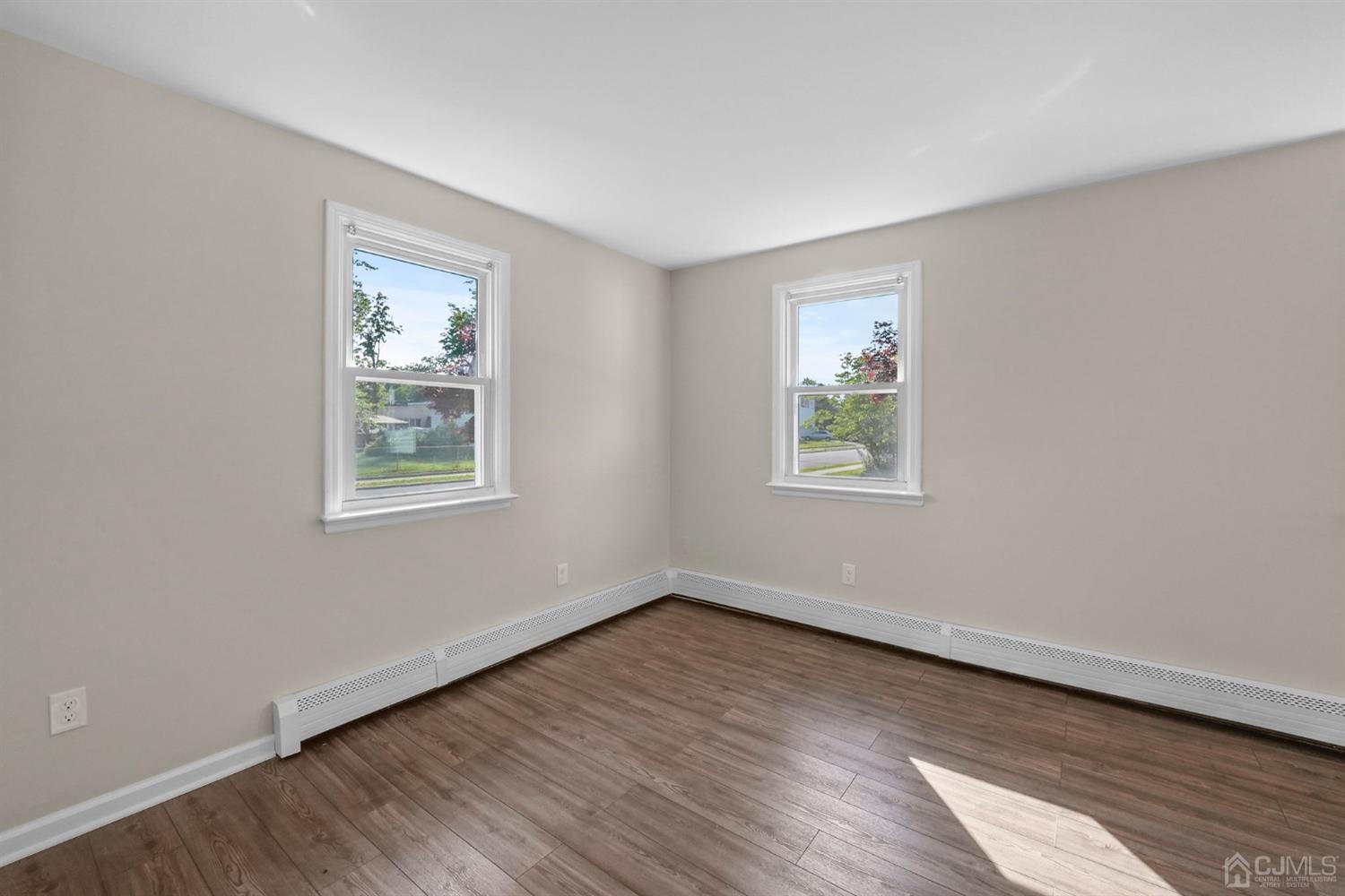 1067 Riverton Street North Brunswick, NJ 08902 - Photo 28 of 45 a view of an empty room with wooden floor and a window