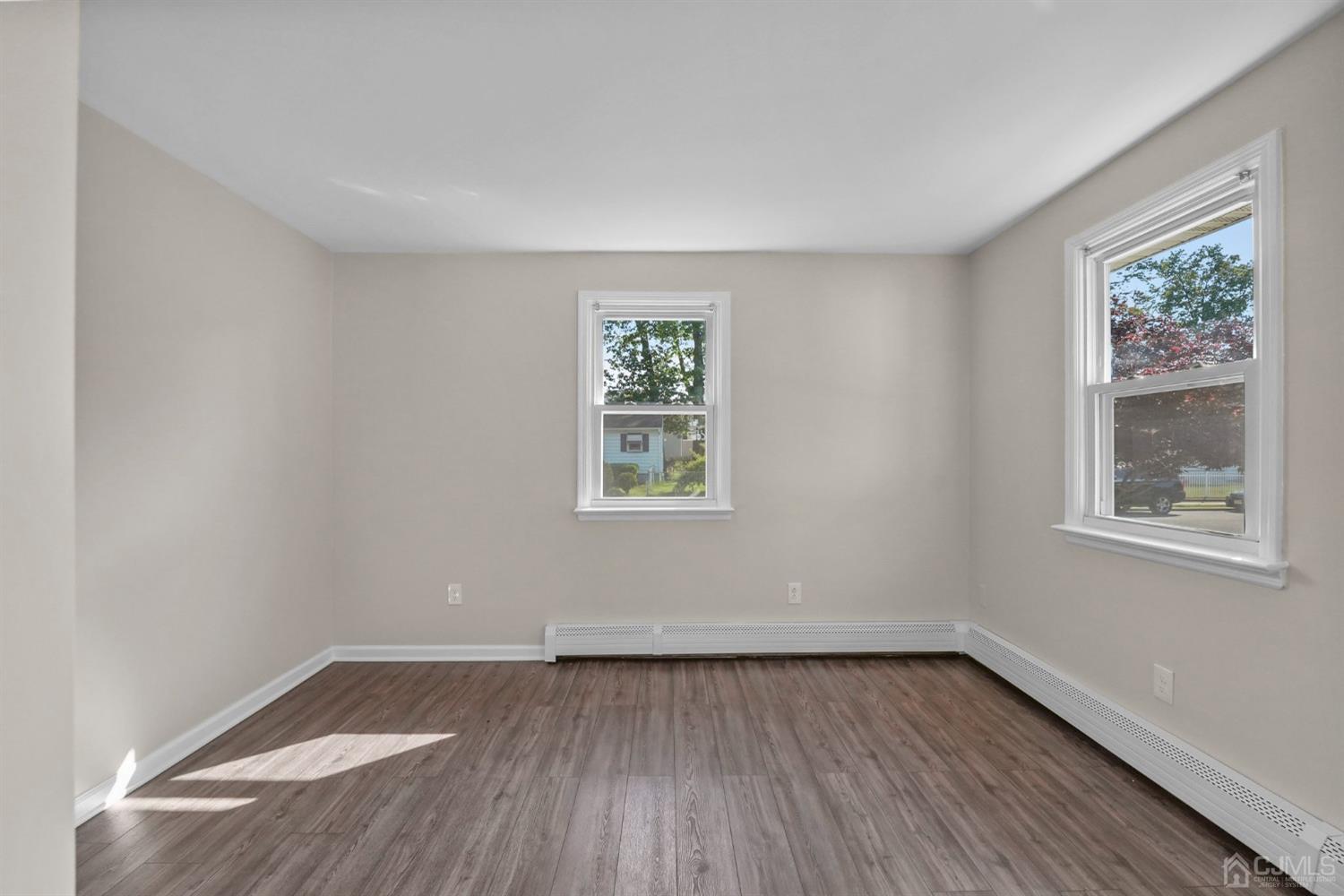 1067 Riverton Street North Brunswick, NJ 08902 - Photo 31 of 45 a view of an empty room with wooden floor and a window