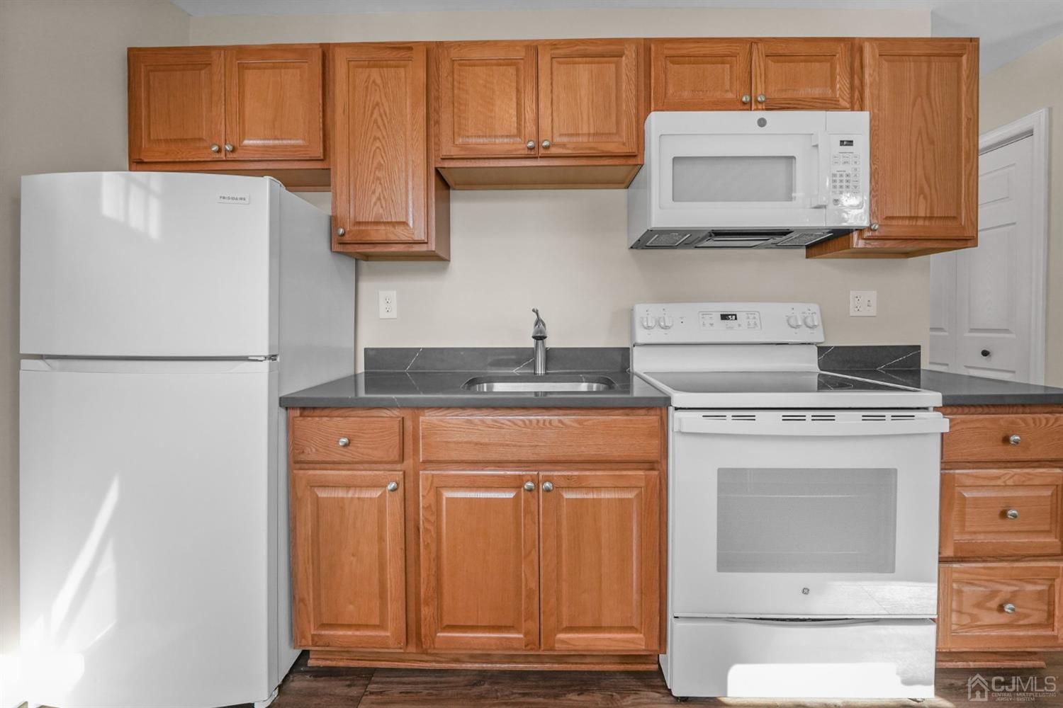1067 Riverton Street North Brunswick, NJ 08902 - Photo 36 of 45 a kitchen with stainless steel appliances granite countertop a refrigerator and a stove top oven