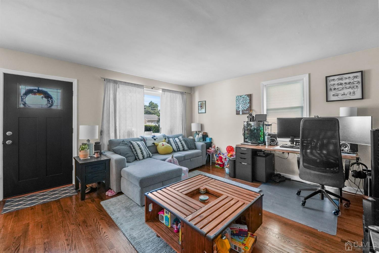 1067 Riverton Street North Brunswick, NJ 08902 - Photo 5 of 45 a living room with furniture and a wooden floor