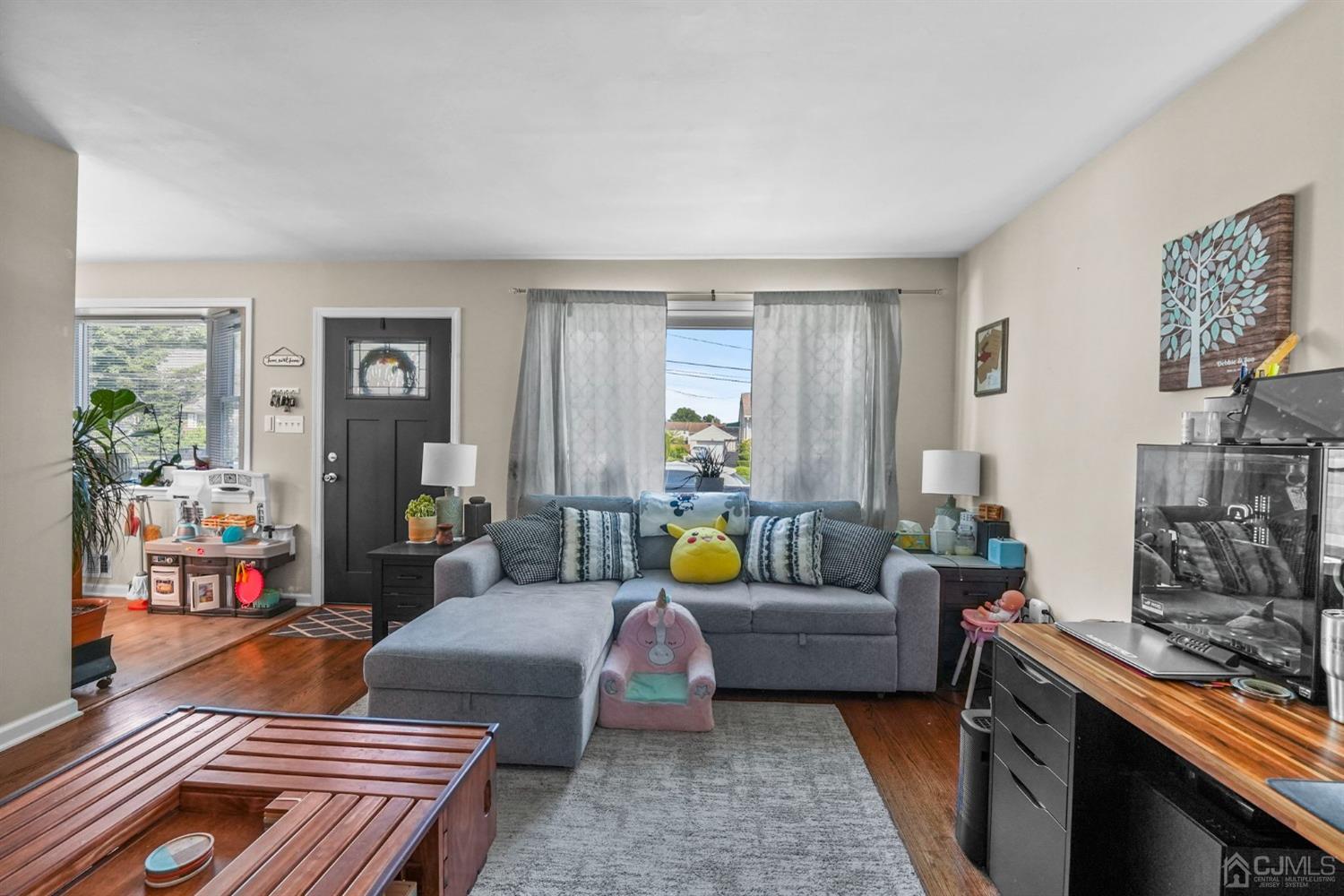 1067 Riverton Street North Brunswick, NJ 08902 - Photo 6 of 45 a living room with furniture and wooden floor