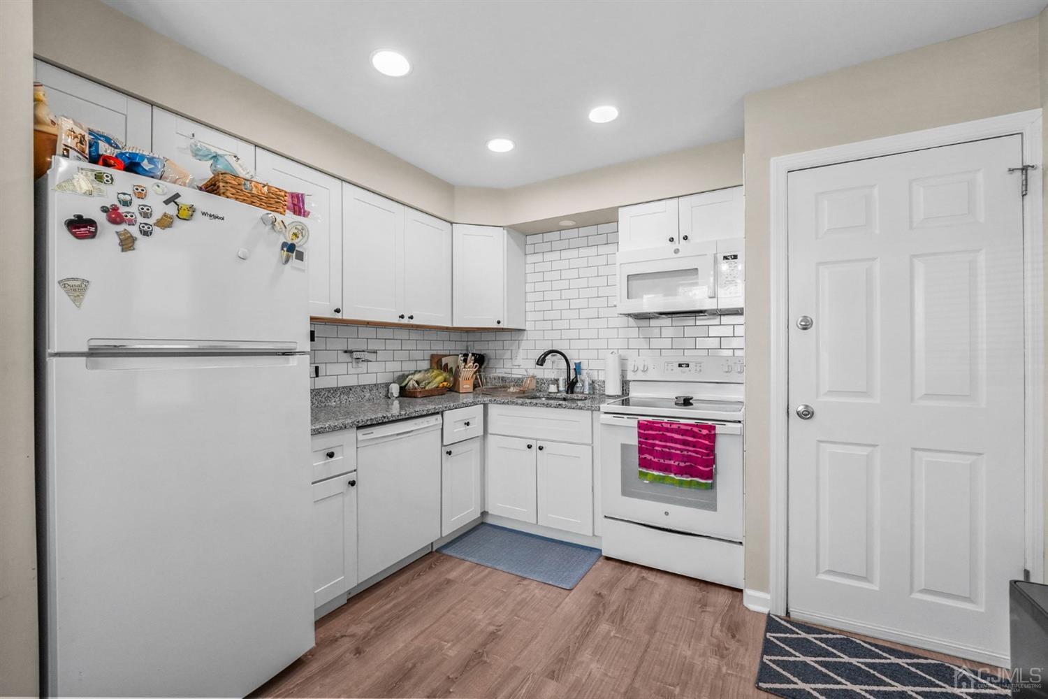 1067 Riverton Street North Brunswick, NJ 08902 - Photo 9 of 45 a kitchen with refrigerator and cabinets