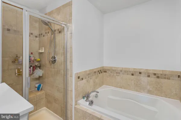 a bathroom with a sink toilet vanity and tub