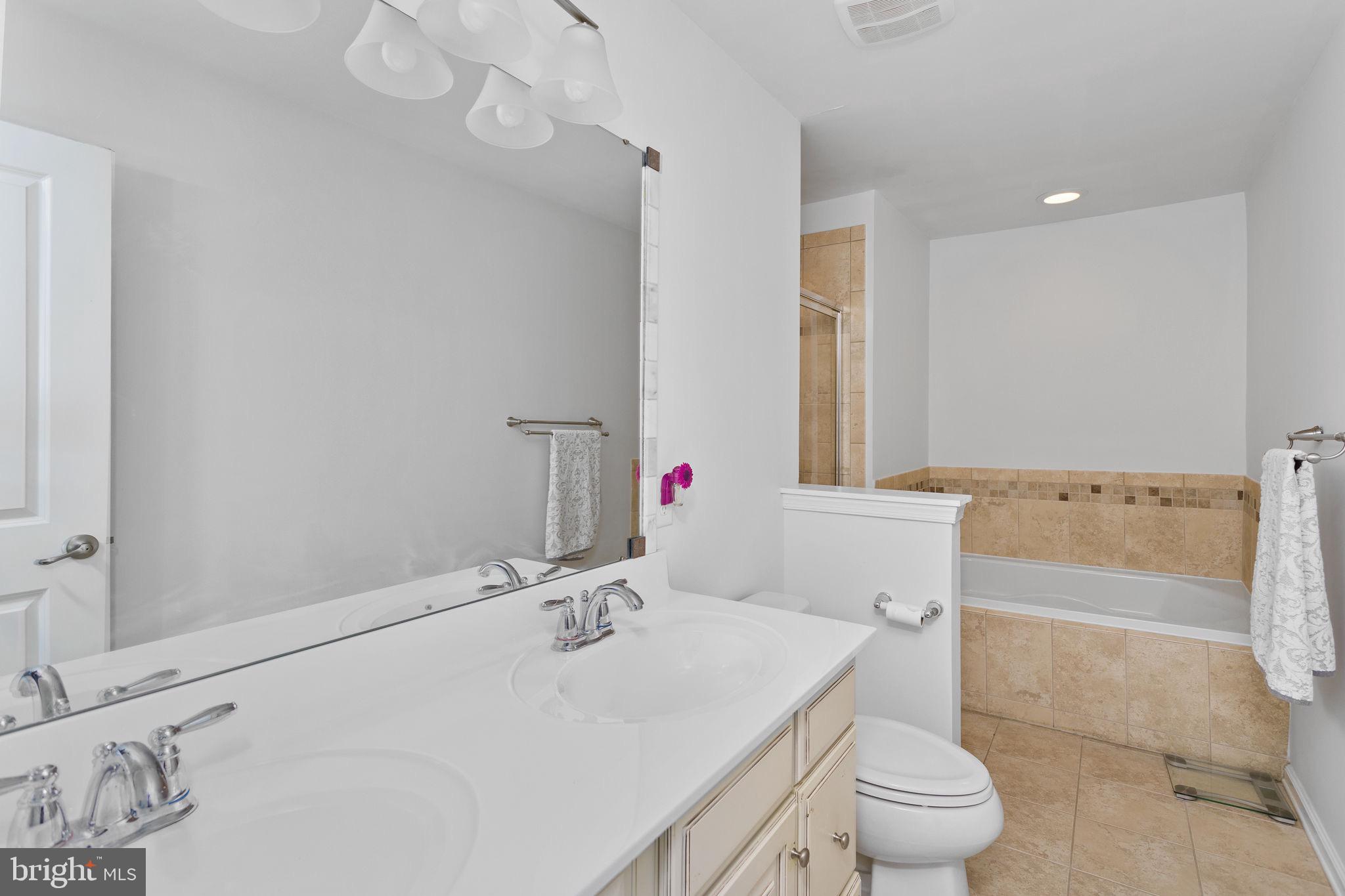 21 Sundance Drive Hamilton, NJ 08619 - Photo 21 of 29 a bathroom with a sink toilet vanity and tub