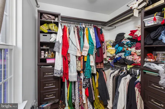 a bedroom with a bed a couch and a window