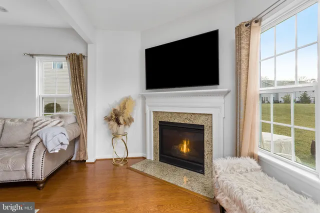 a living room with a fireplace and a flat screen tv