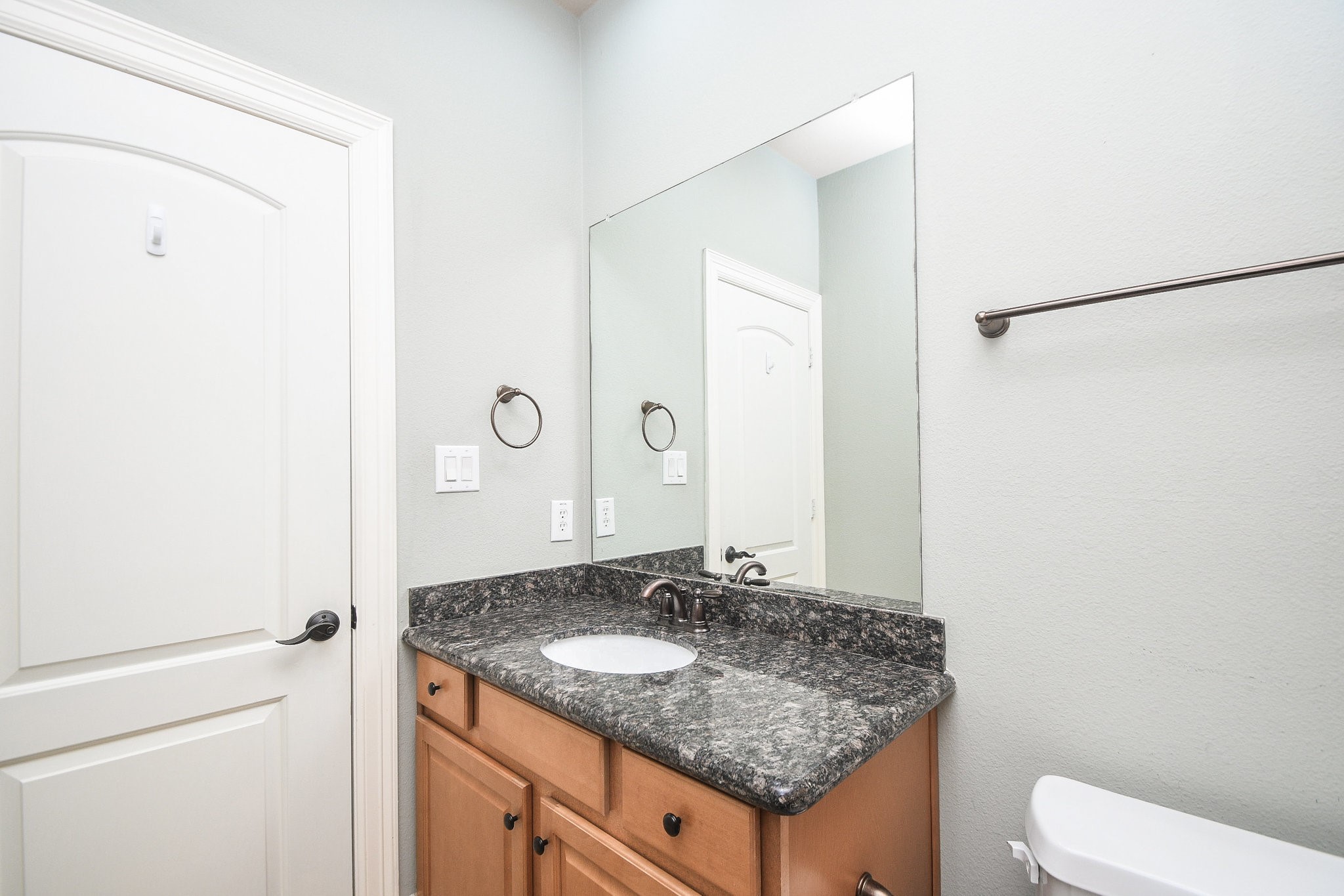 1222 West 17th Street, Unit D Houston, TX 77008 - Photo 28 of 35 a bathroom with a granite countertop sink and a mirror