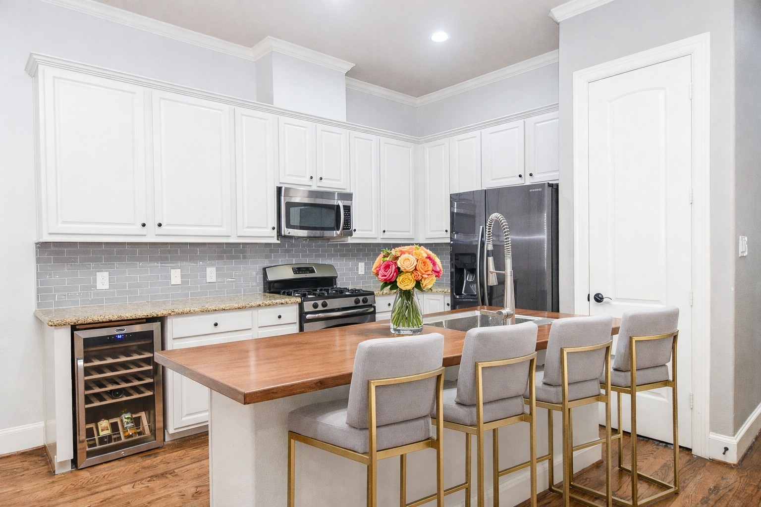 1222 West 17th Street, Unit D Houston, TX 77008 - Photo 3 of 38 a kitchen with stainless steel appliances a stove a sink refrigerator and microwave