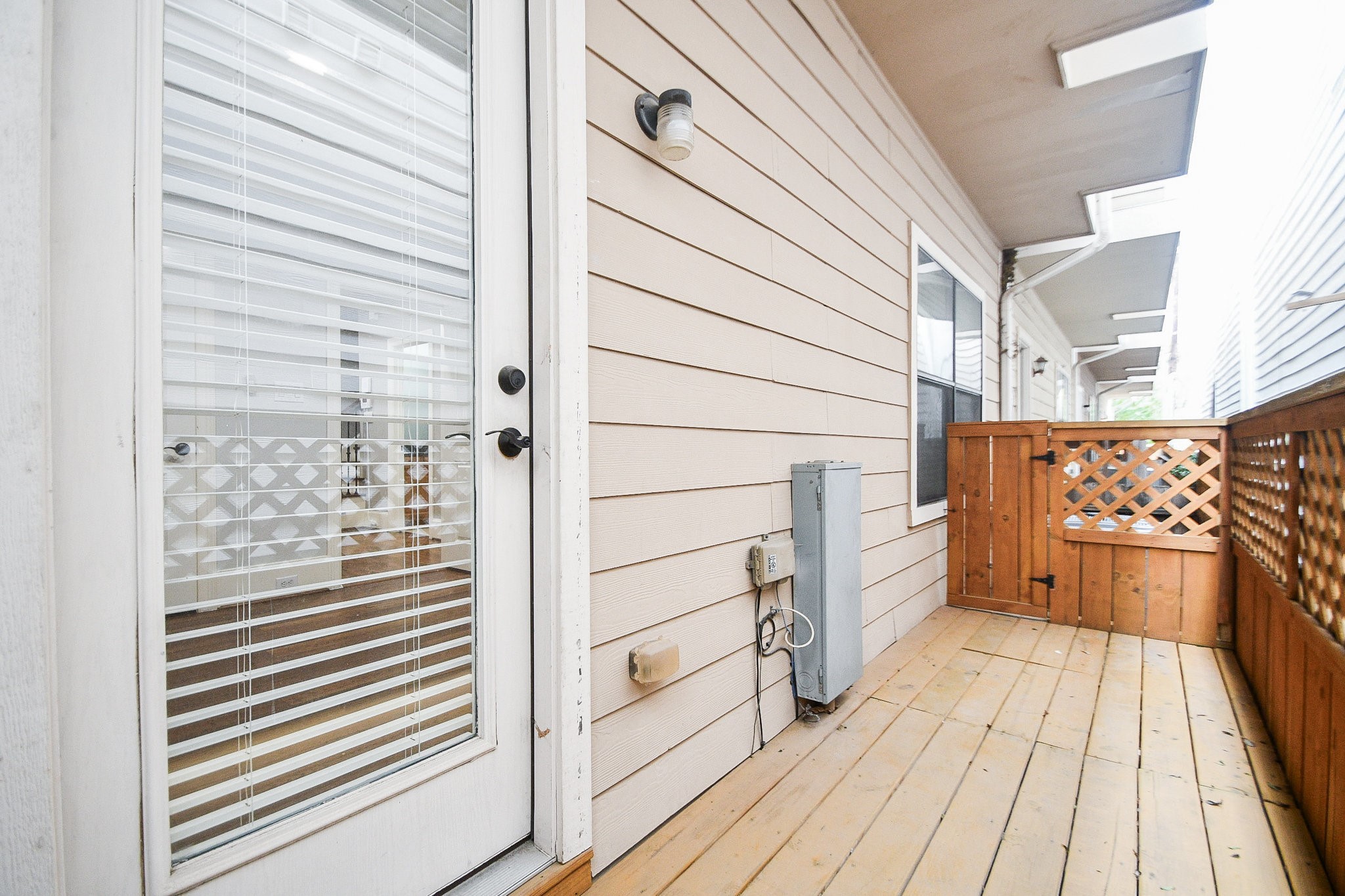 1222 West 17th Street, Unit D Houston, TX 77008 - Photo 32 of 38 a view of a balcony with wooden floor and cabinets