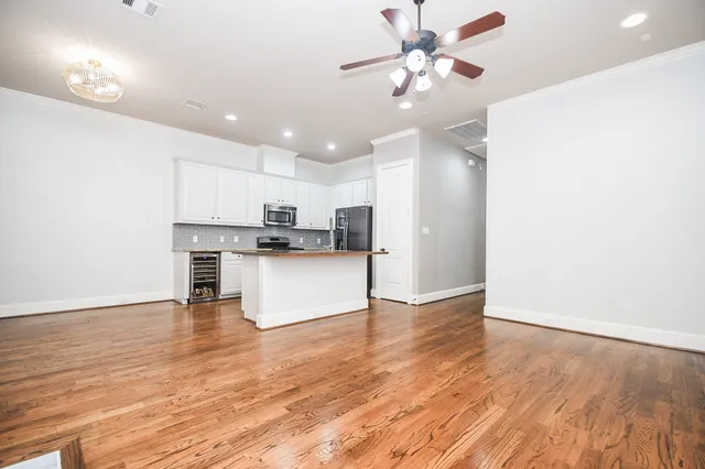 a view of kitchen with granite countertop cabinets and refrigerator