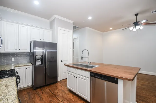 a kitchen that has a refrigerator a sink and dishwasher