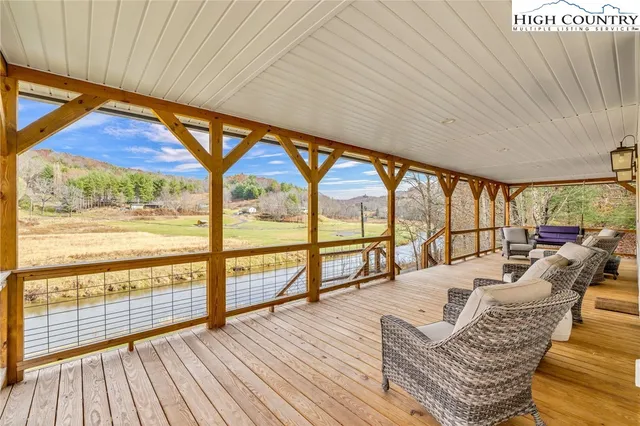 a living room with large windows and wooden floor