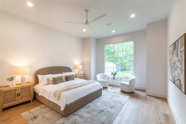 a bedroom with a large bed and a window