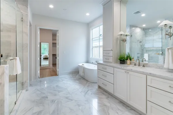 a large bathroom with a double vanity sink a large mirror and shower