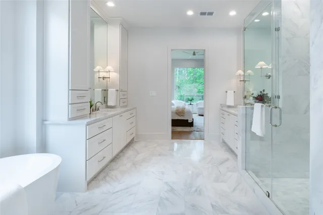 a spacious bathroom with a double vanity sink a mirror and a shower