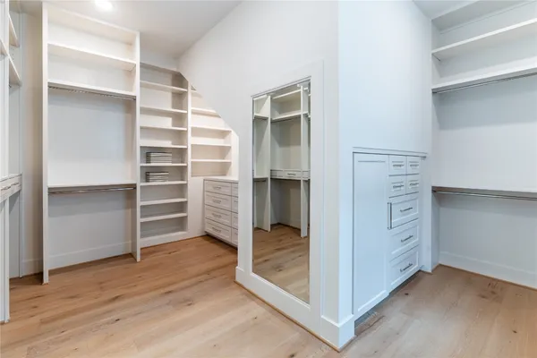 a view of an empty walk in closet and a bathroom