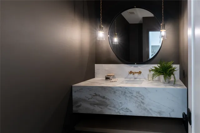 a bathroom with a sink a mirror and vanity