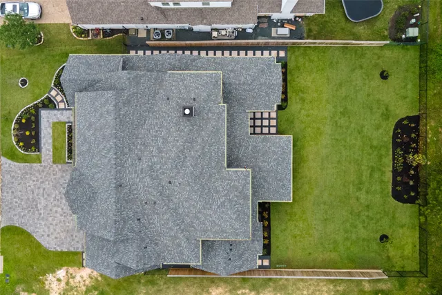 an aerial view of a house with a yard