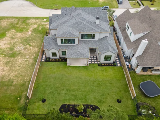 a aerial view of a house with swimming pool garden and patio