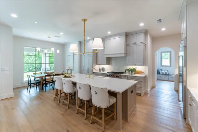 a large kitchen with a table and chairs