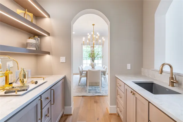 a kitchen with a sink a stove and cabinets