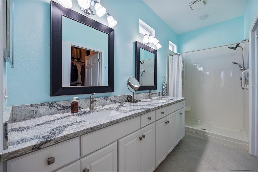 20907 Tangor Road Land O Lakes, FL 34637 - Photo 12 of 49 a bathroom with a double vanity sink and a mirror