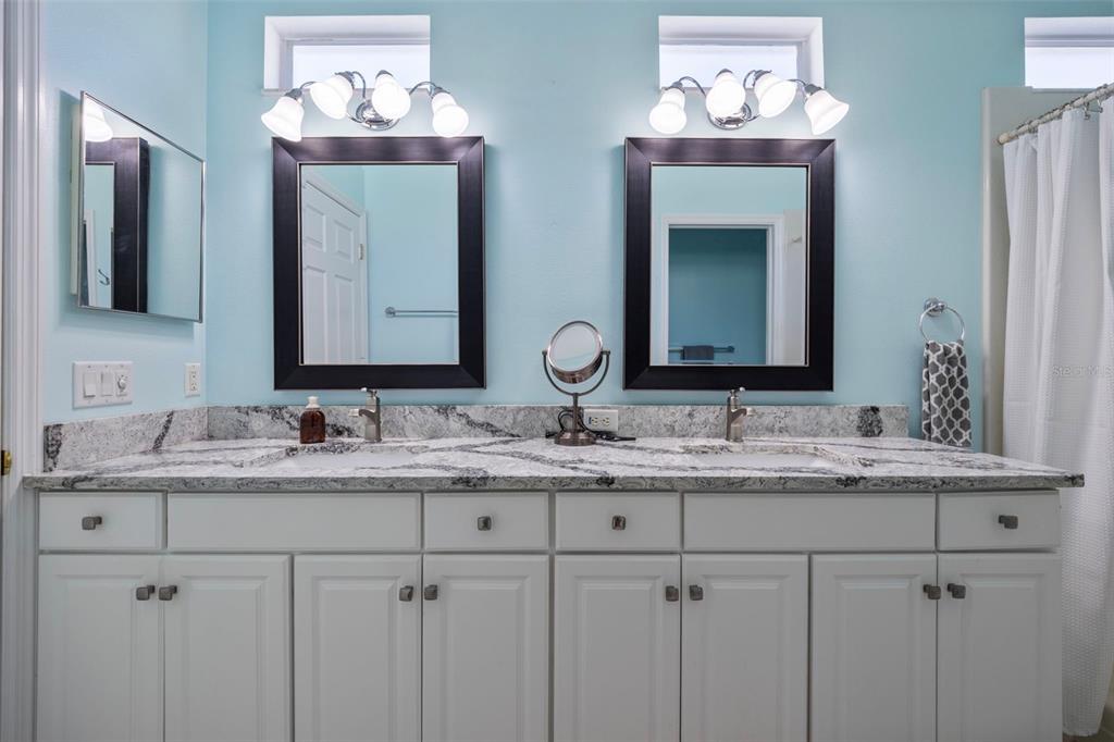 20907 Tangor Road Land O Lakes, FL 34637 - Photo 13 of 49 a bathroom with double vanity sinks and a mirror