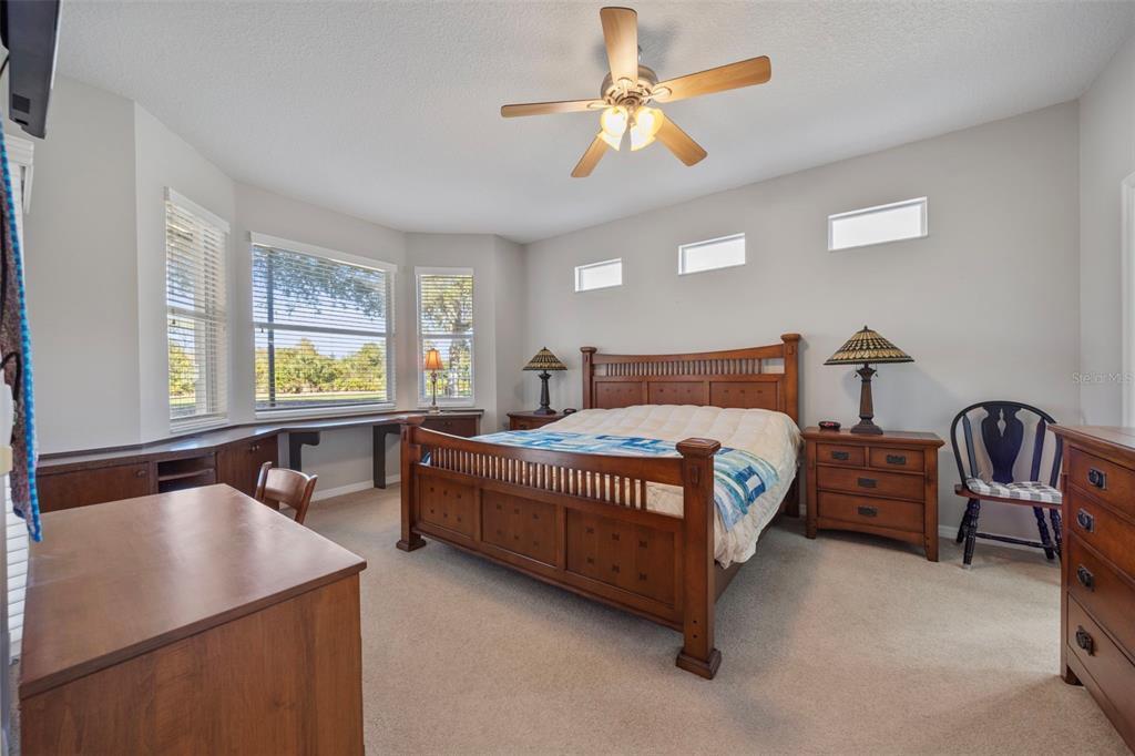 20907 Tangor Road Land O Lakes, FL 34637 - Photo 14 of 49 a bedroom with a bed chair and window