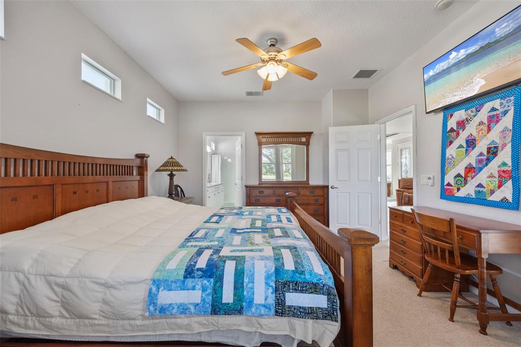 20907 Tangor Road Land O Lakes, FL 34637 - Photo 15 of 49 a bedroom with a bed and a chandelier
