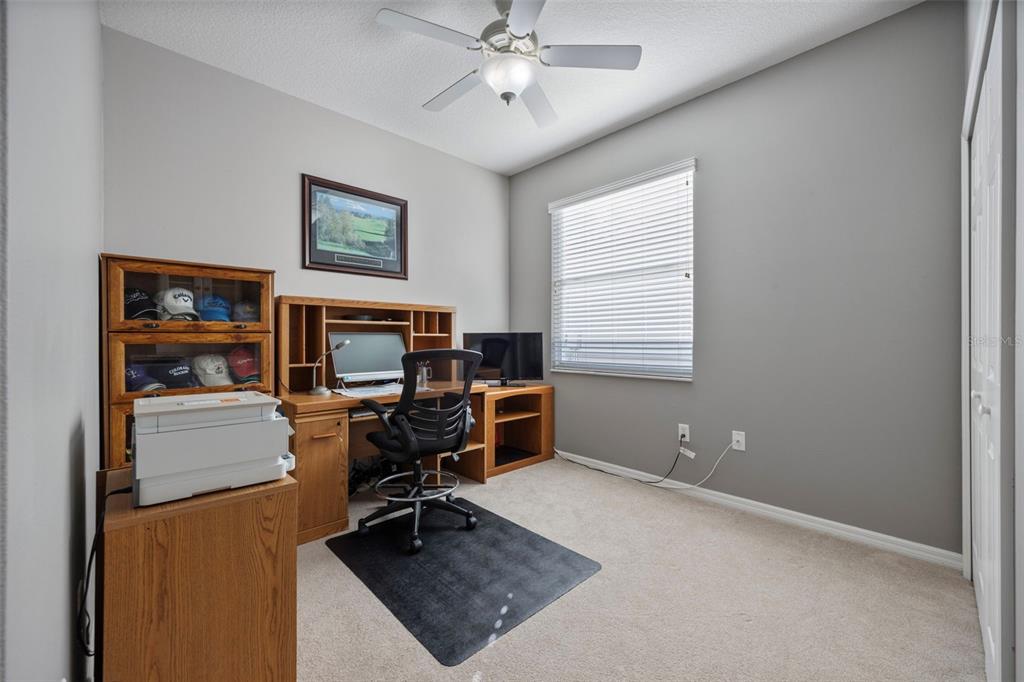 20907 Tangor Road Land O Lakes, FL 34637 - Photo 19 of 49 a view of a workspace with furniture and a window