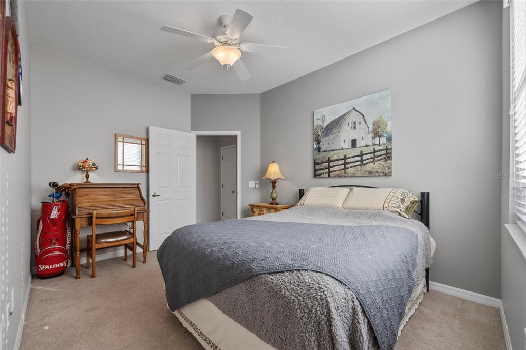 20907 Tangor Road Land O Lakes, FL 34637 - Photo 20 of 49 a bedroom with a bed and a chandelier