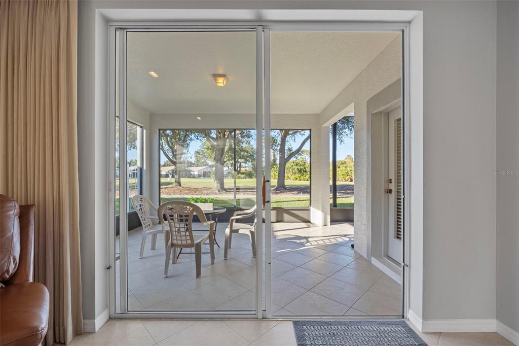 20907 Tangor Road Land O Lakes, FL 34637 - Photo 23 of 49 a view of a dining room with furniture and floor to ceiling window