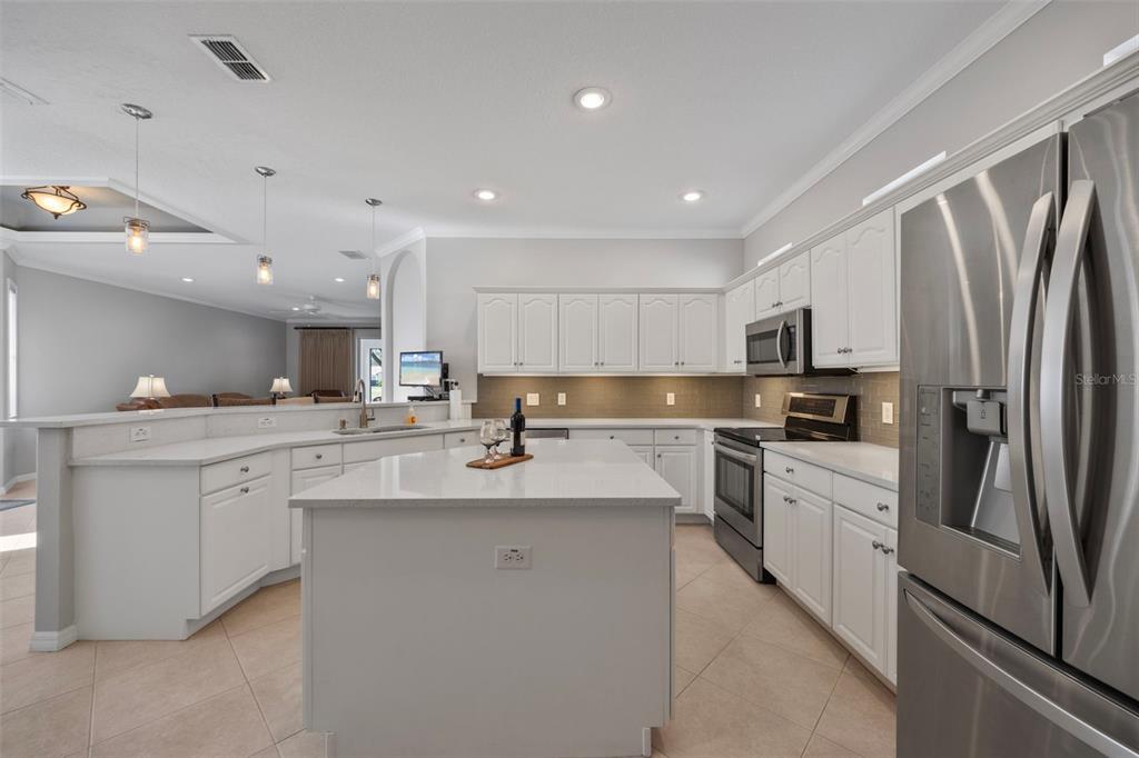 20907 Tangor Road Land O Lakes, FL 34637 - Photo 3 of 49 a kitchen with white cabinets appliances and sink
