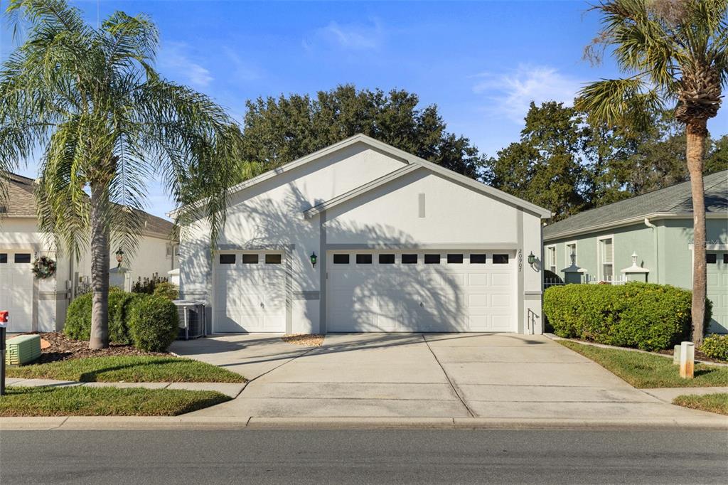 20907 Tangor Road Land O Lakes, FL 34637 - Photo 46 of 49 a front view of a house with a yard and garage