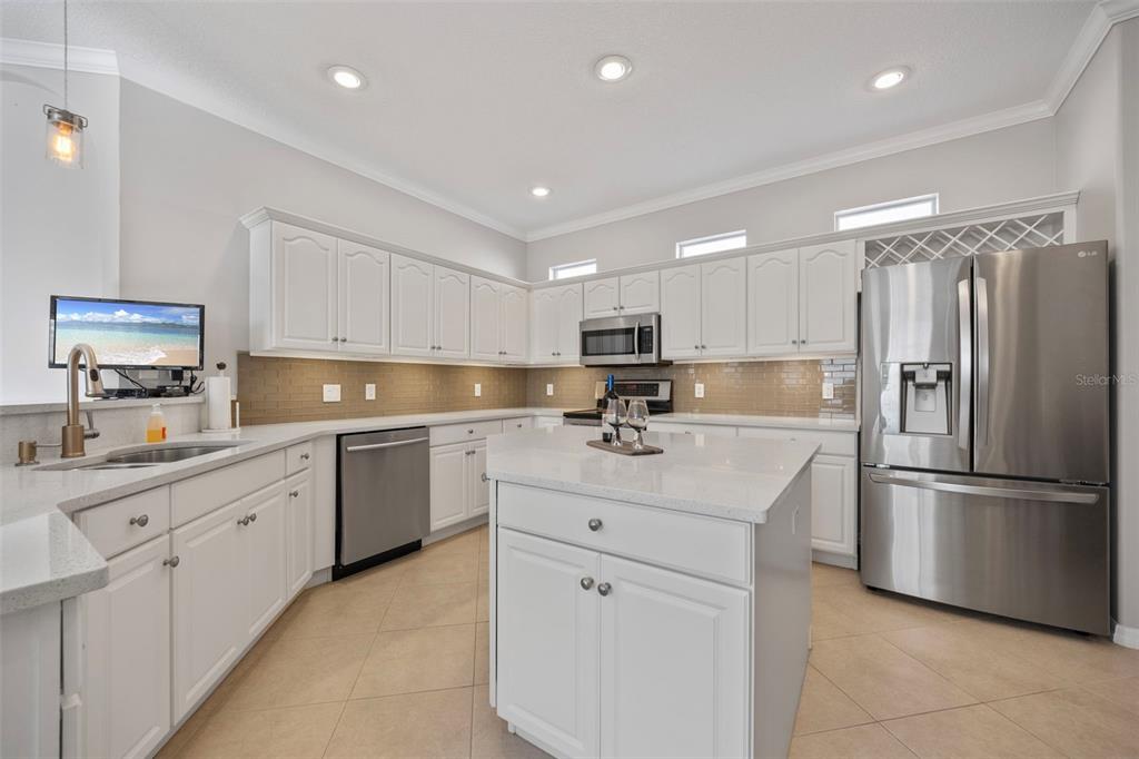 20907 Tangor Road Land O Lakes, FL 34637 - Photo 7 of 49 a kitchen with white cabinets and stainless steel appliances