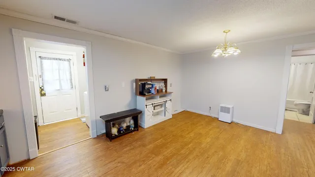 a view of a livingroom with a furniture and a chandelier