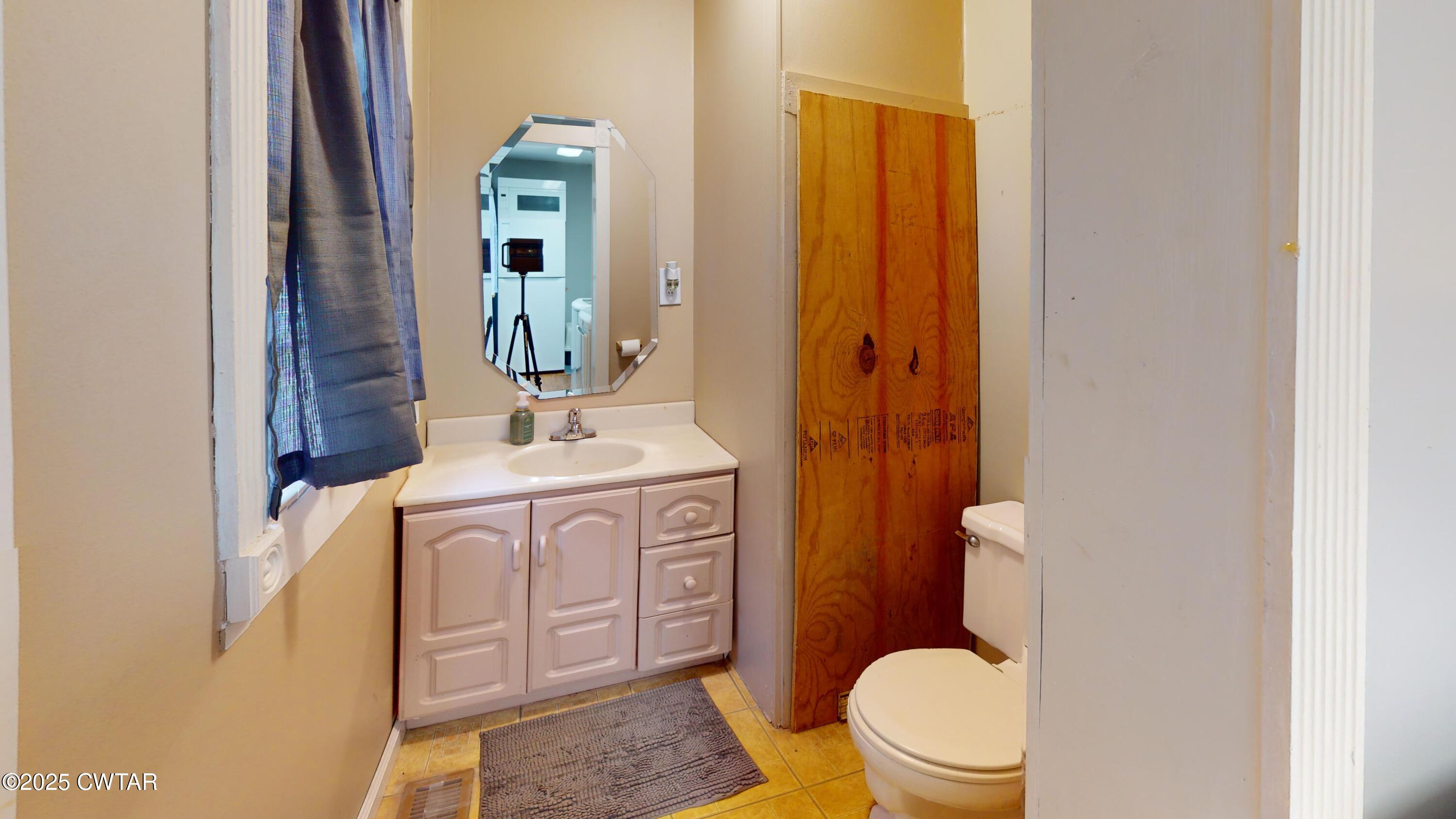 429 Church Street Ridgely, TN 38080 - Photo 17 of 35 a bathroom with a sink a toilet and mirror