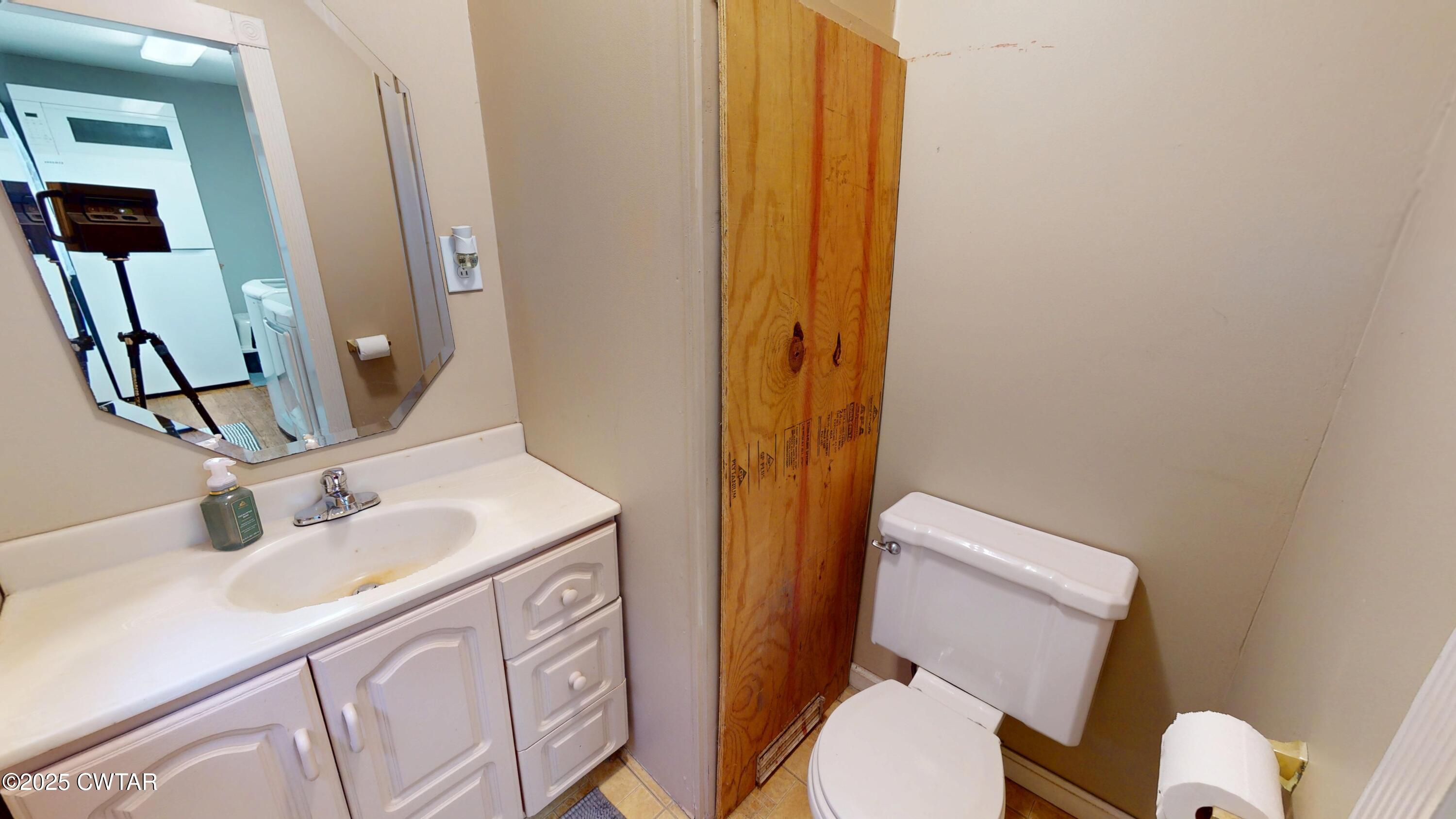 429 Church Street Ridgely, TN 38080 - Photo 18 of 35 a bathroom with a sink a toilet and shower curtain