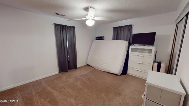 a view of a room with wooden floor and cabinet