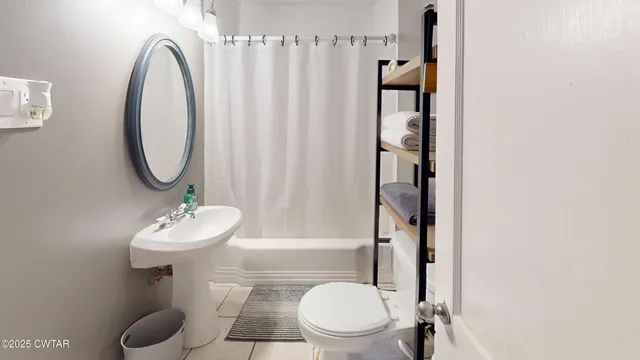 a bathroom with a mirror a sink and a mirror