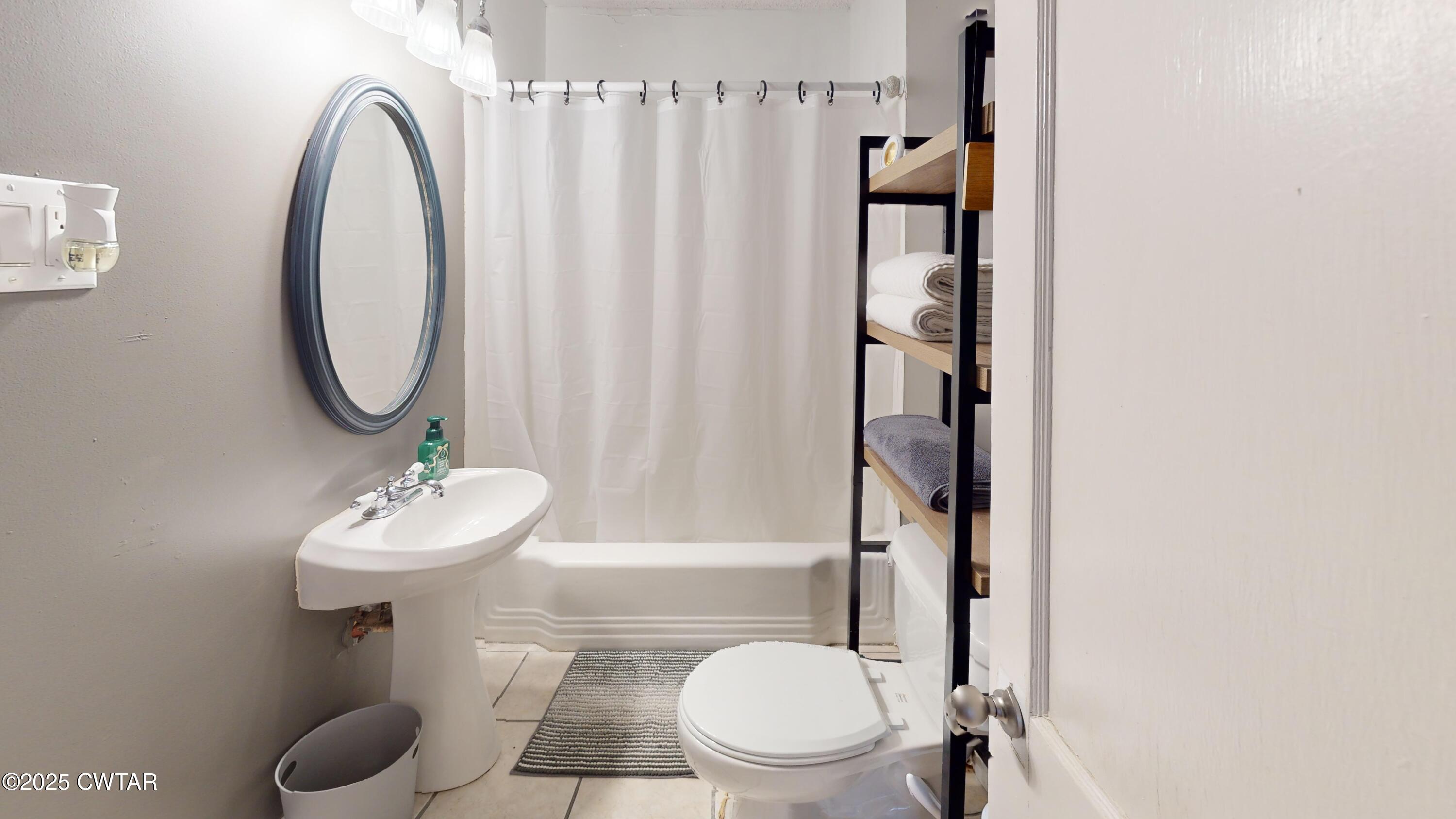 429 Church Street Ridgely, TN 38080 - Photo 25 of 35 a bathroom with a sink toilet and shower