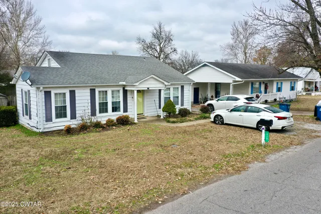 a view of a car parked in front of a house