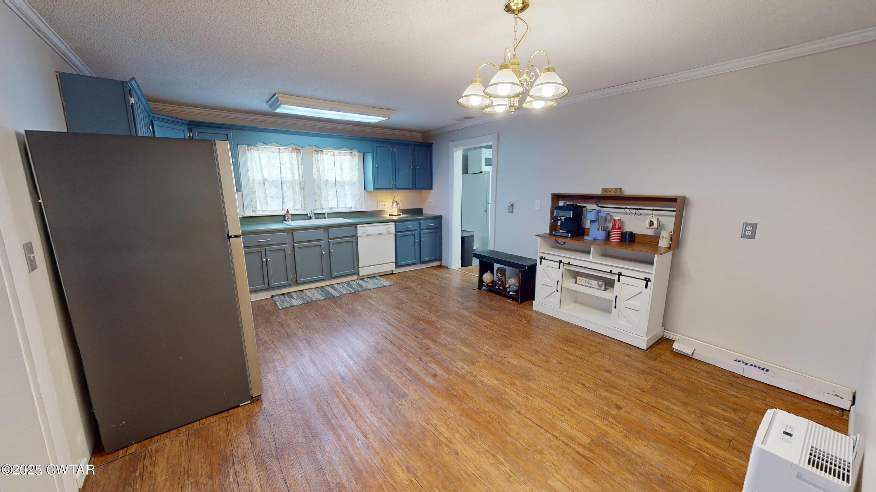 429 Church Street Ridgely, TN 38080 - Photo 7 of 35 a kitchen with stainless steel appliances a refrigerator and a wooden floor