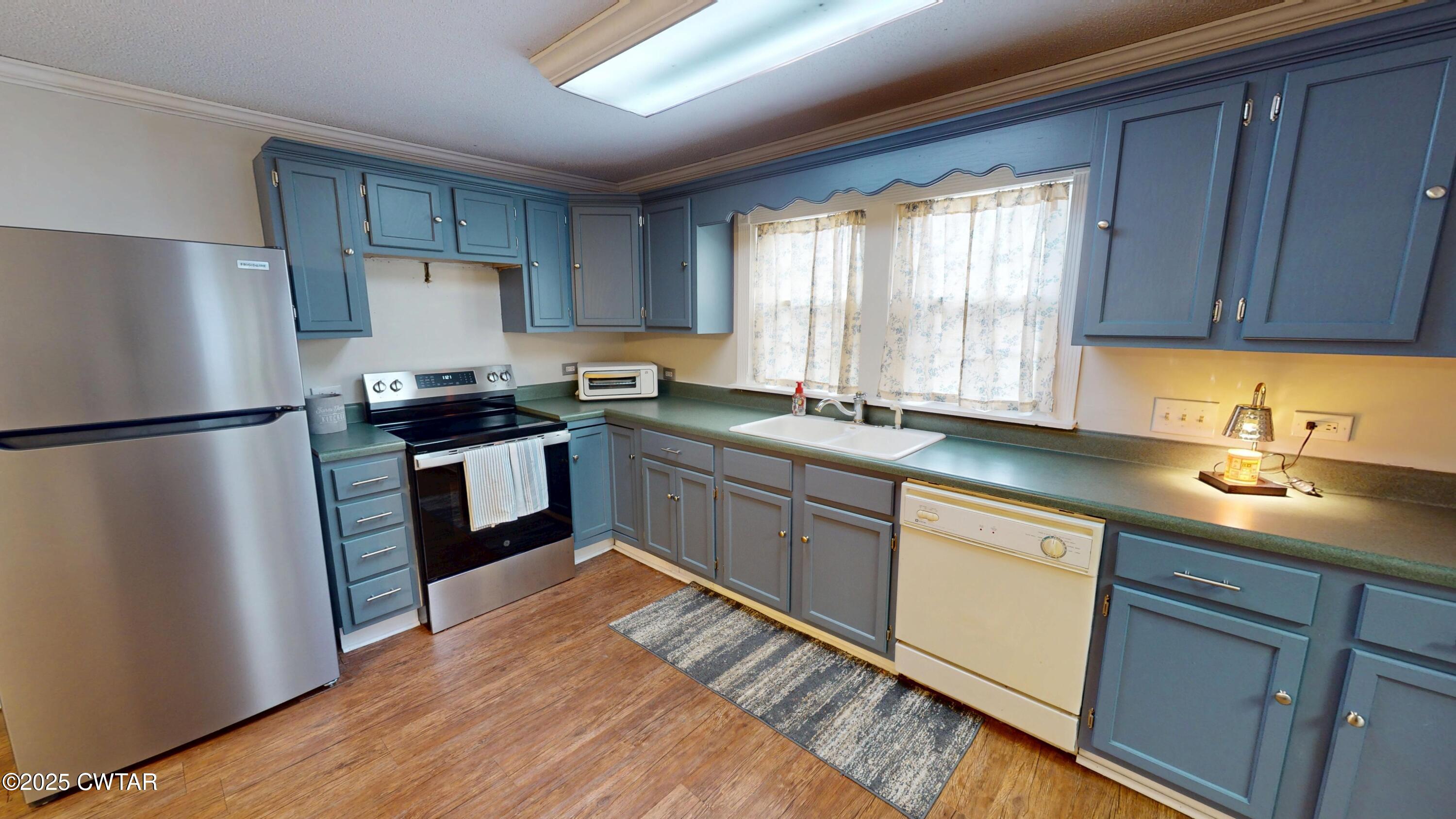 429 Church Street Ridgely, TN 38080 - Photo 10 of 35 a kitchen with a sink stove and refrigerator