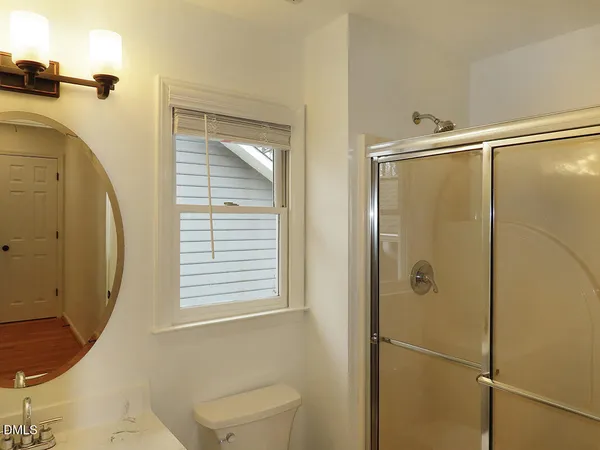 a bathroom with a shower and a toilet