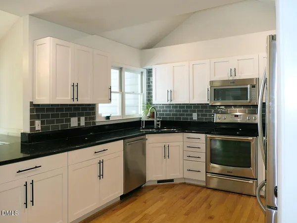 a kitchen with granite countertop a stove and a sink
