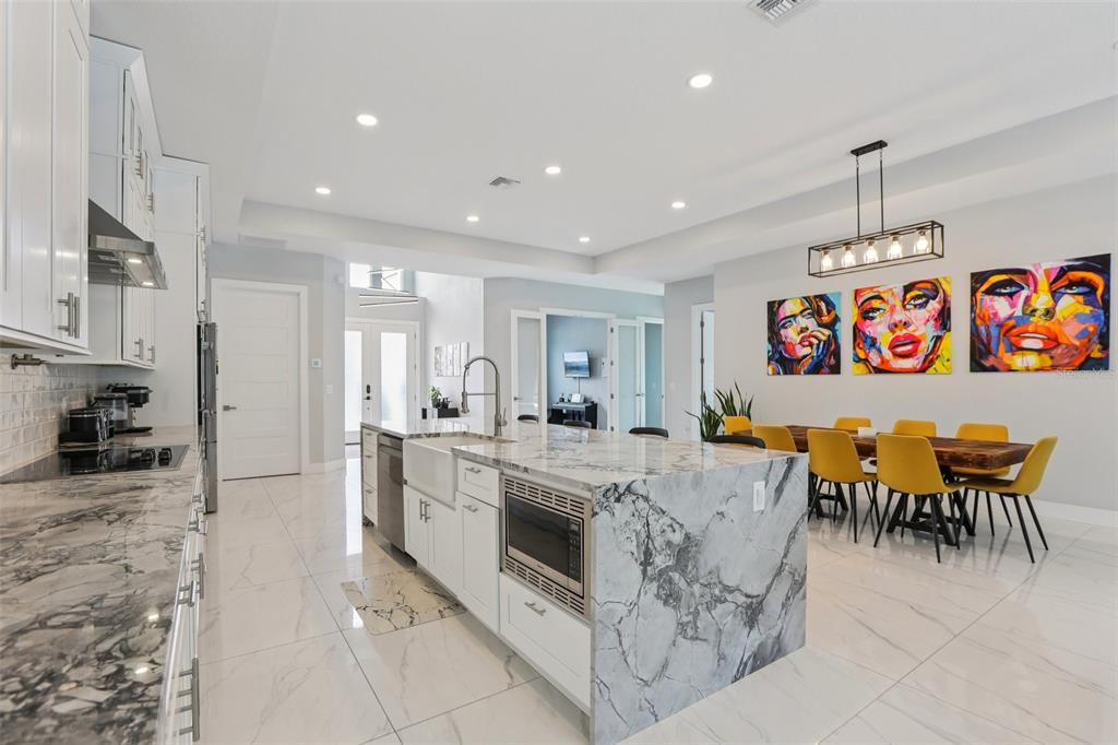 352 Mehlenbacher Road Belleair, FL 33756 - Photo 28 of 88 a large white kitchen with stainless steel appliances granite countertop a stove and white cabinets